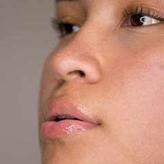 Close-up of a person's nose and mouth with a neutral background
