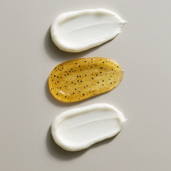 Three swatches of cream on a gray background