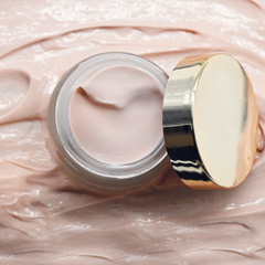 Yumi Skincare Glow Up Night Crea, in a jar with gold lid on a tpink cream bottom
