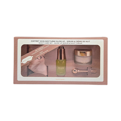 Cosmetic set with serum, cream, and tools in a box on a white background