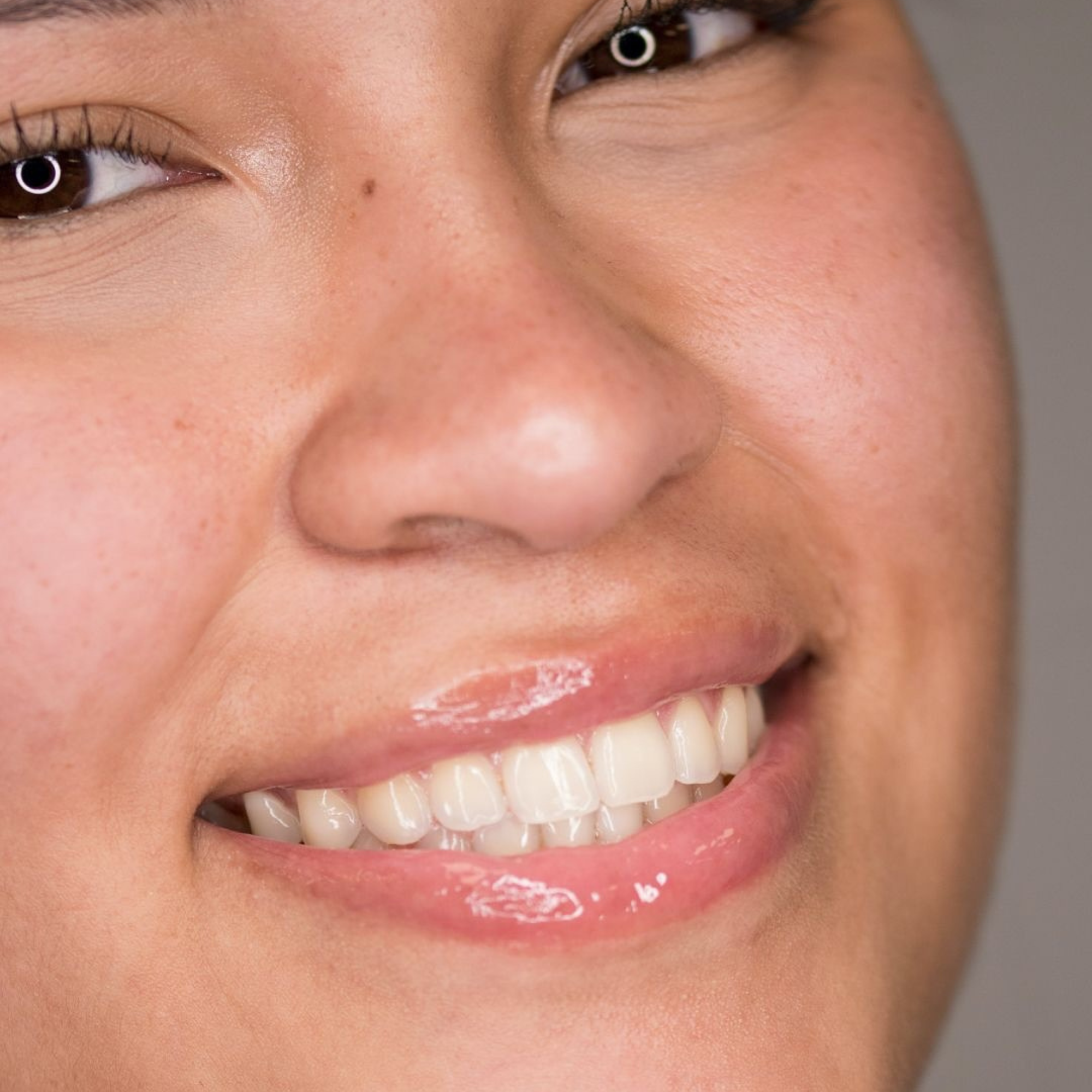 Close-up of a person's face with a neutral background