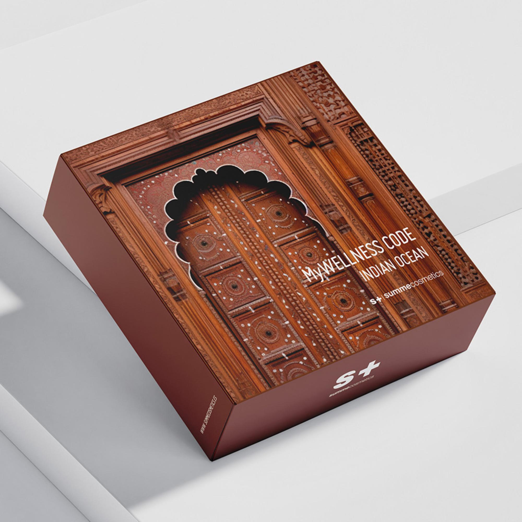 Decorative box with intricate design and 'Wellness Code Indian Ocean' branding on a light gray background